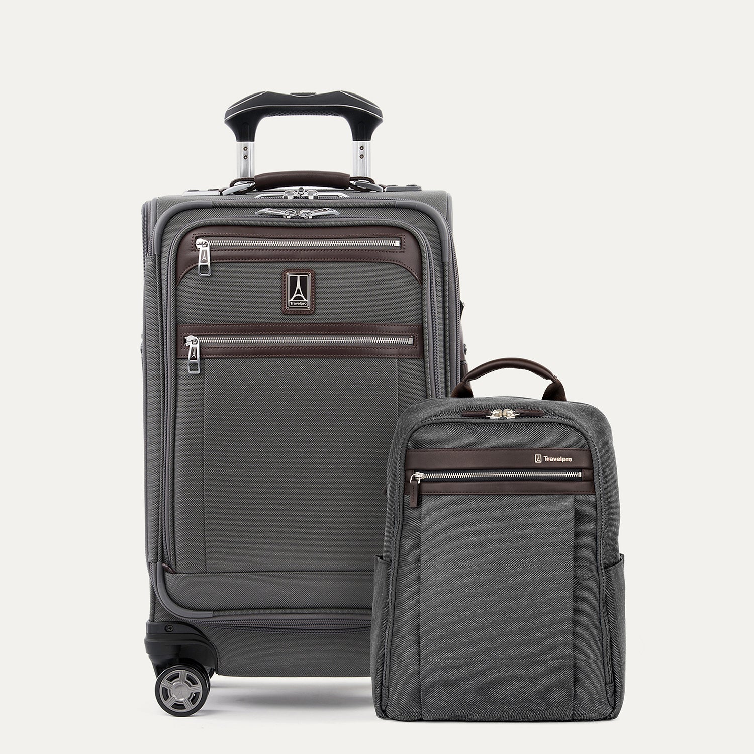 A set of two pieces of luggage, a expandable carry-on spinner suitcase and a smaller slim backpack, both in vintage gray with leather accents on a white background