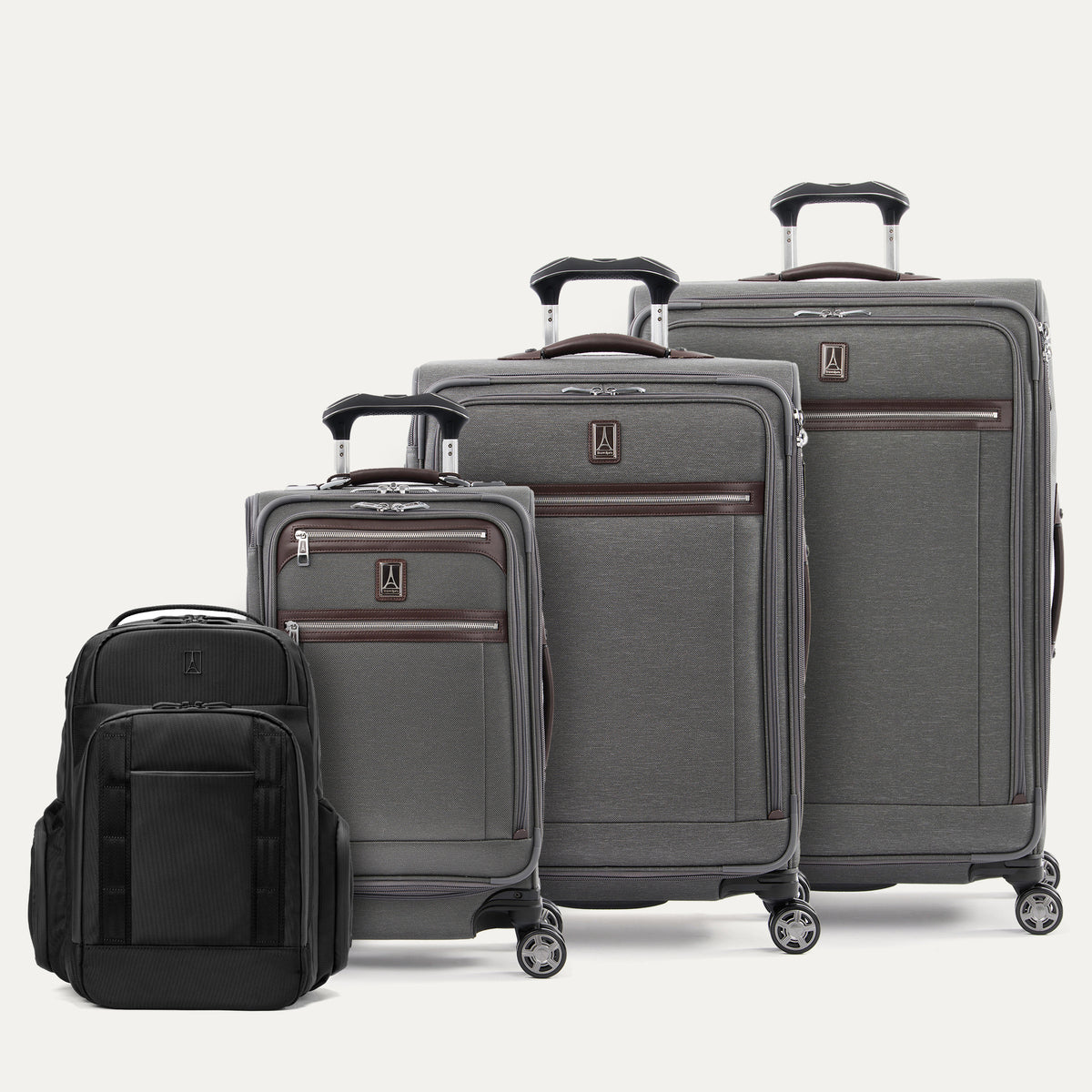 Set of gray suitcases and a black backpack on a white background