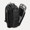 Black backpack with multiple compartments open on a white background