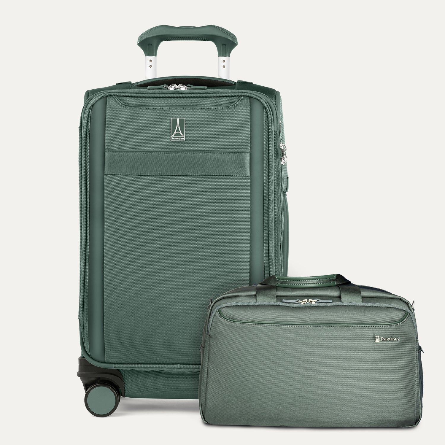 Green suitcase and travel bag set on a light gray background
