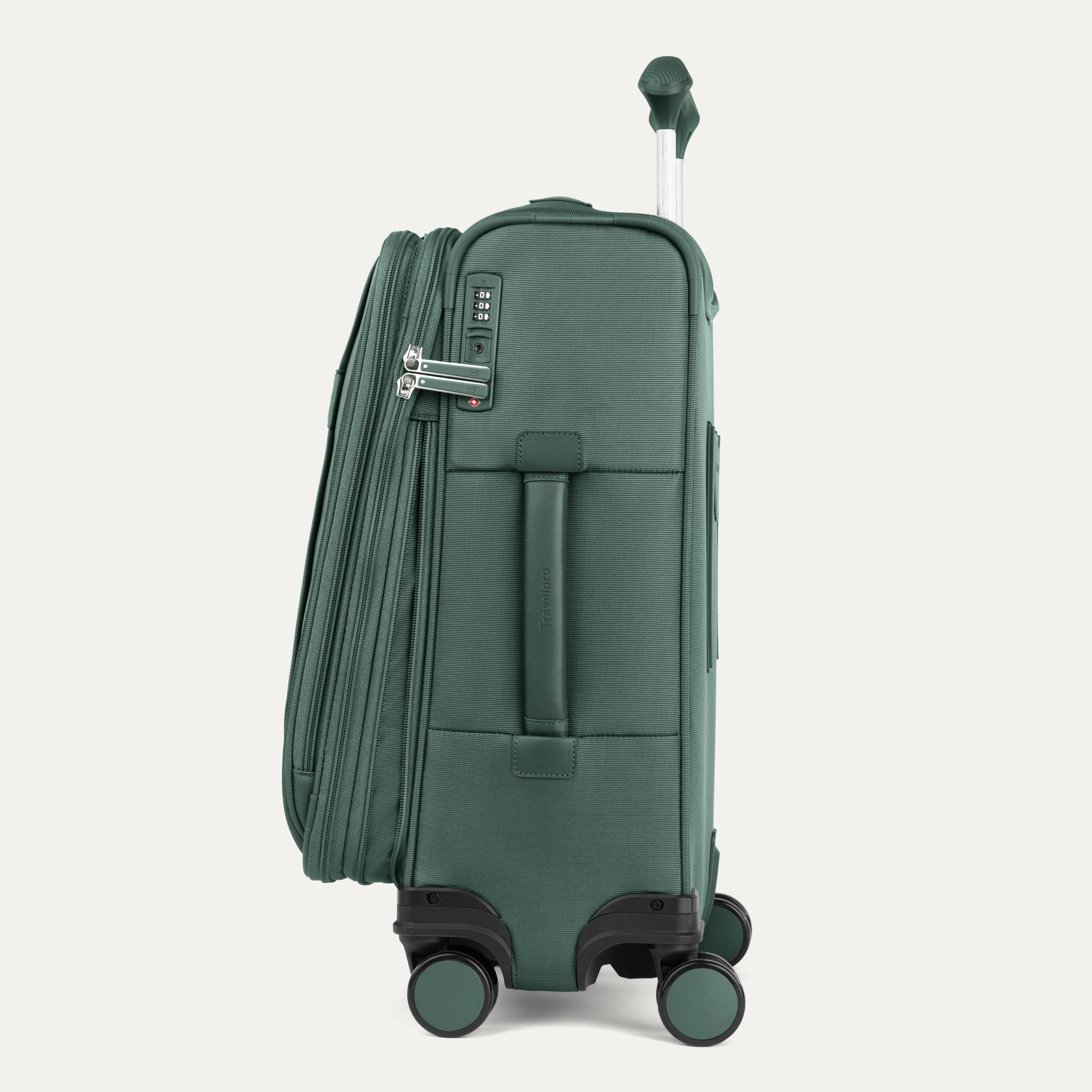 Green suitcase with wheels on a light gray background