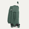 Green suitcase with wheels on a light gray background