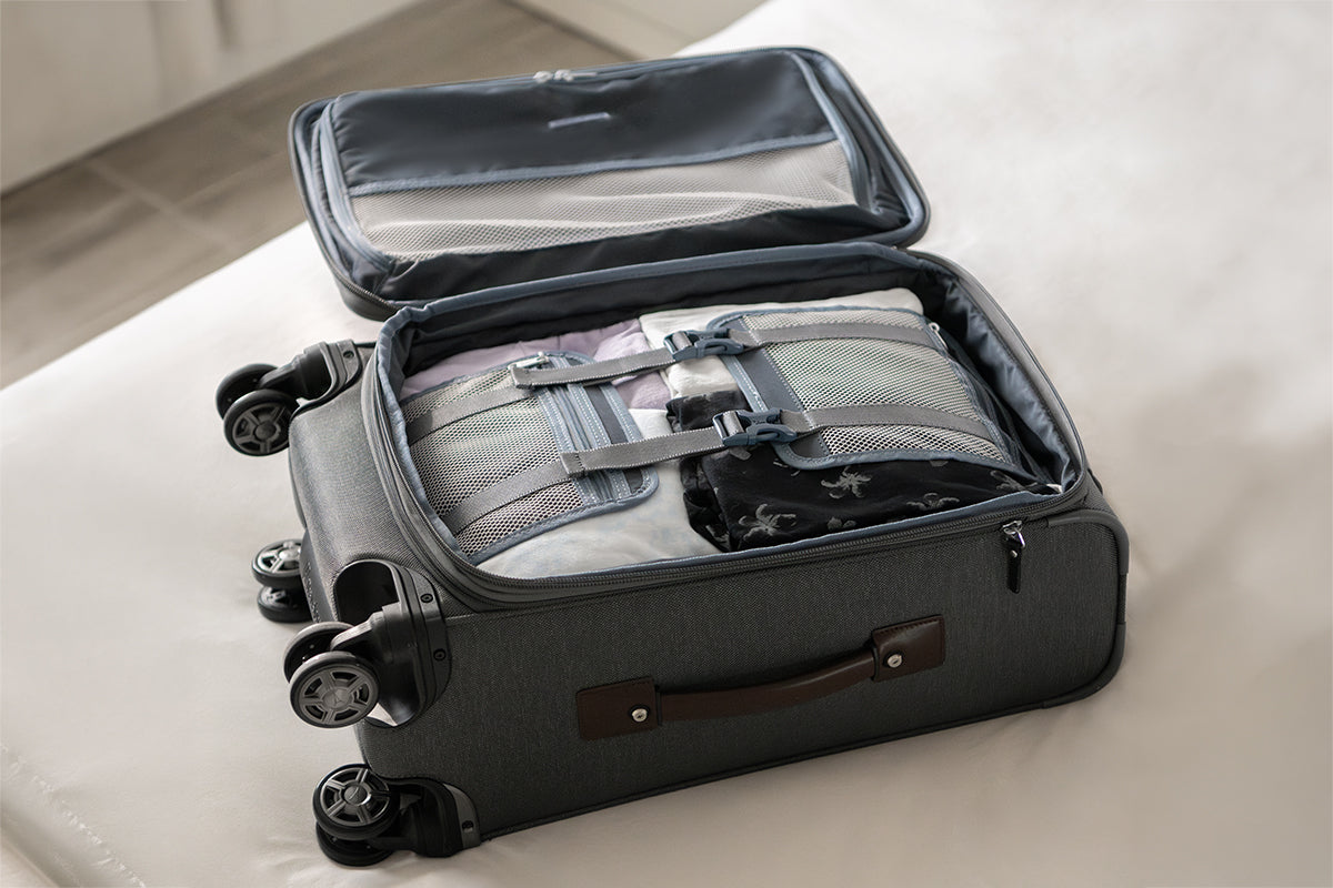 Travelpro carry-on suitcase being packed with tie-down straps