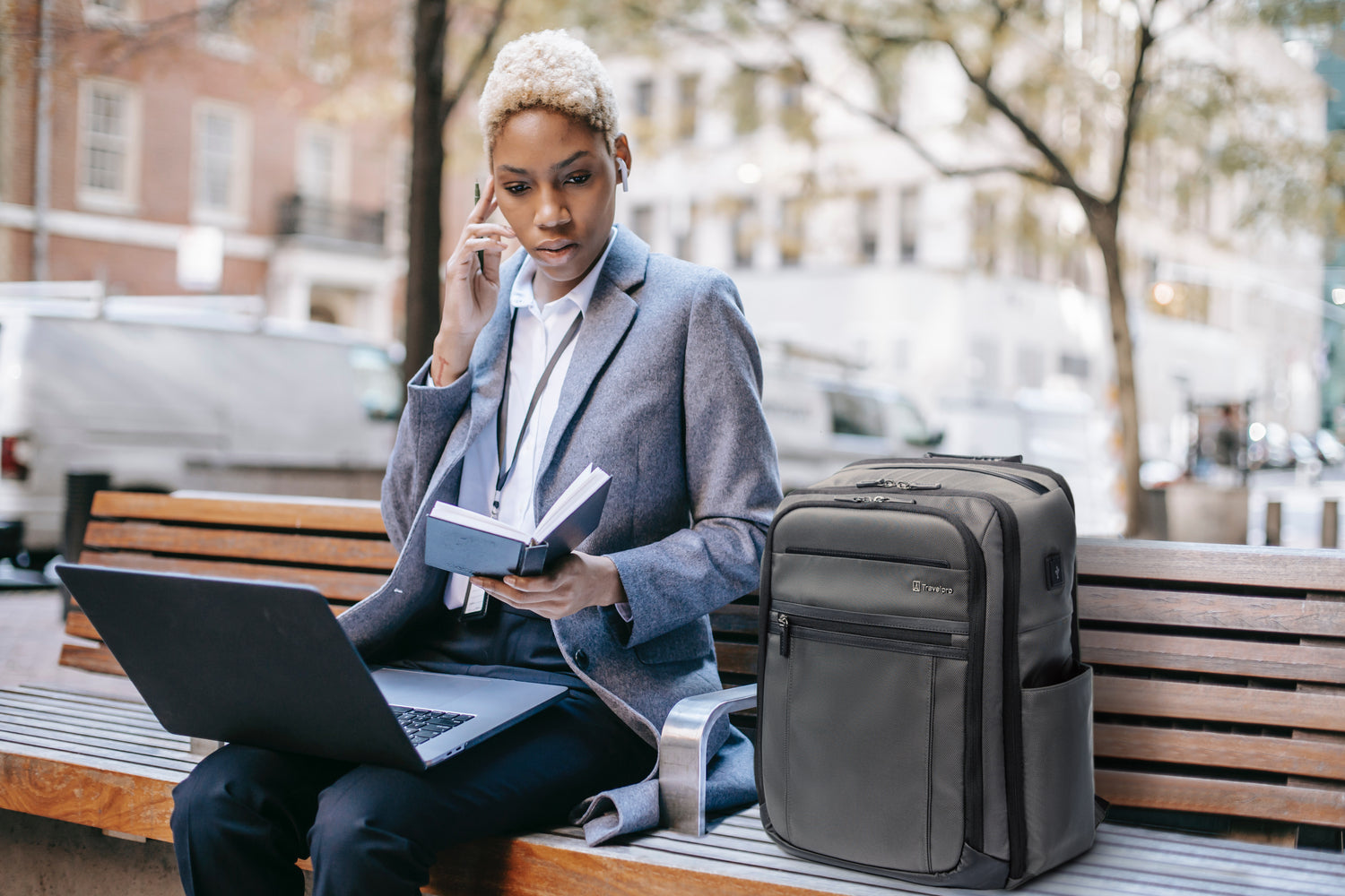 Woman working on laptop outside