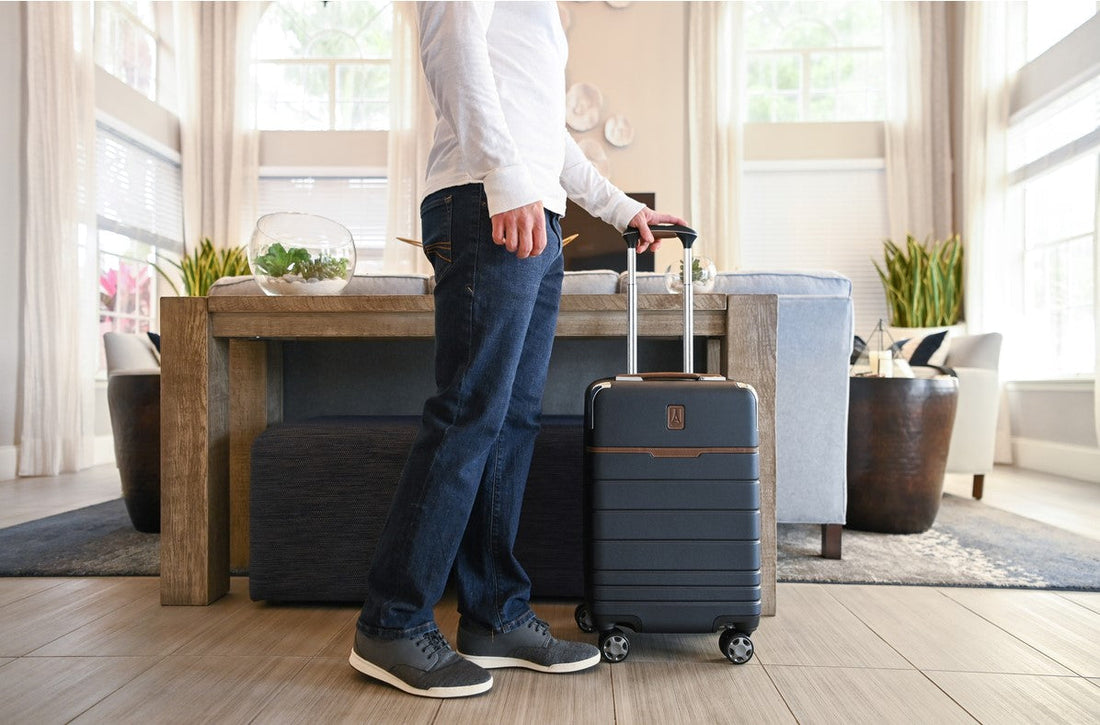 man holding carry-on spinner luggage