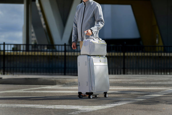 man walking with luggage to airport