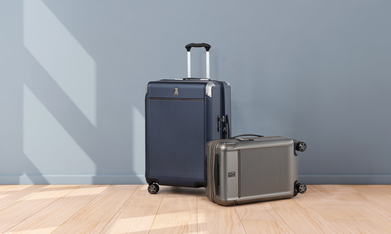 Two pieces of hard side luggage against a minimalist background