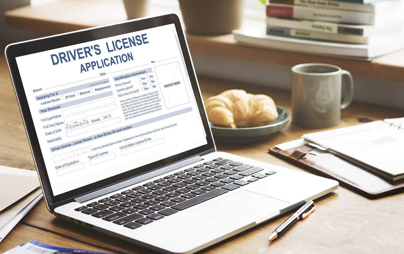 Filling out driver's license application on laptop 