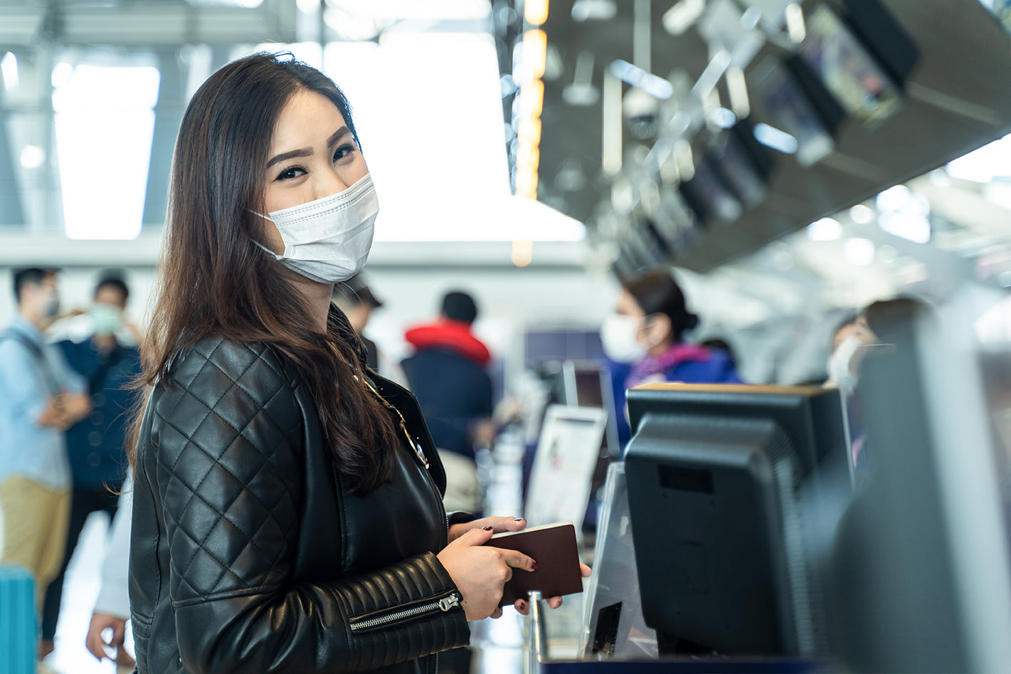 Woman wearing mask checking into a flight