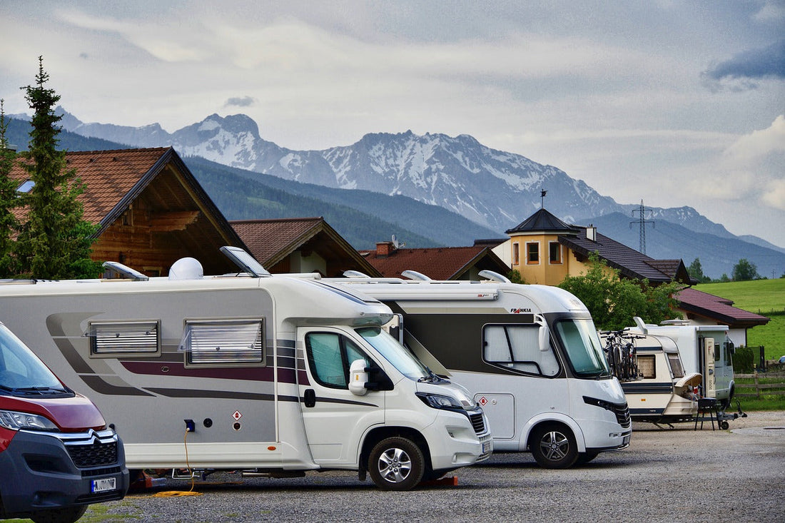 campers in foreground with snowcapped mountains in background