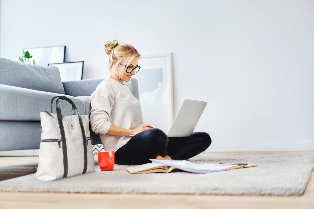 woman sitting on the floor with a laptop