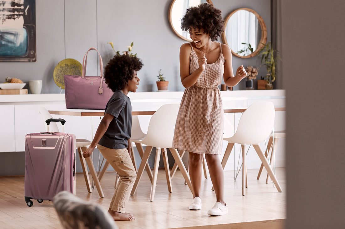 Mother and son dancing in a dining room