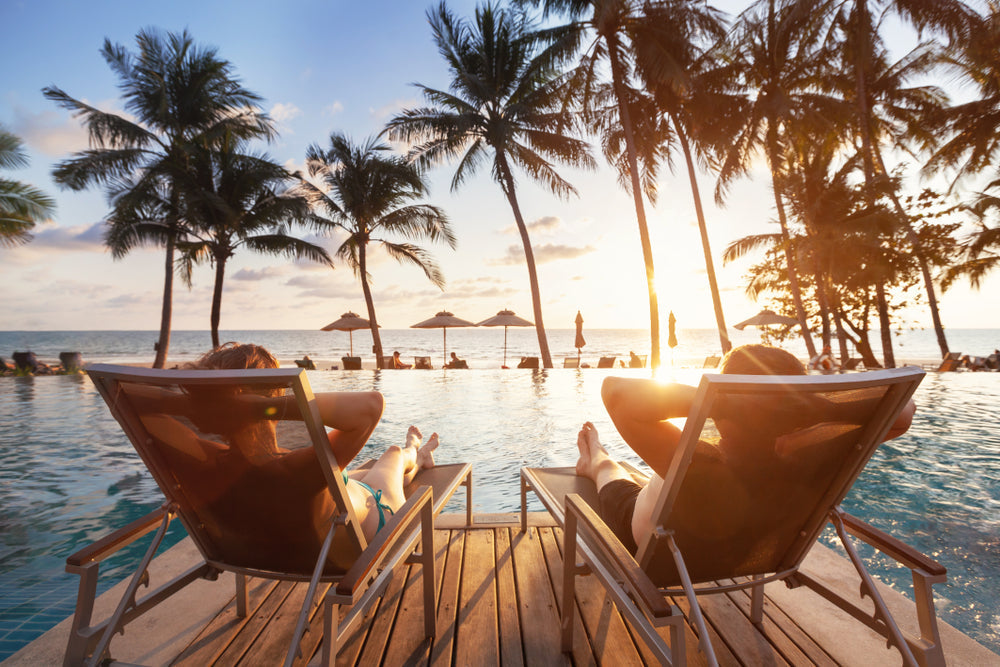couples relaxing by the pool at a resort