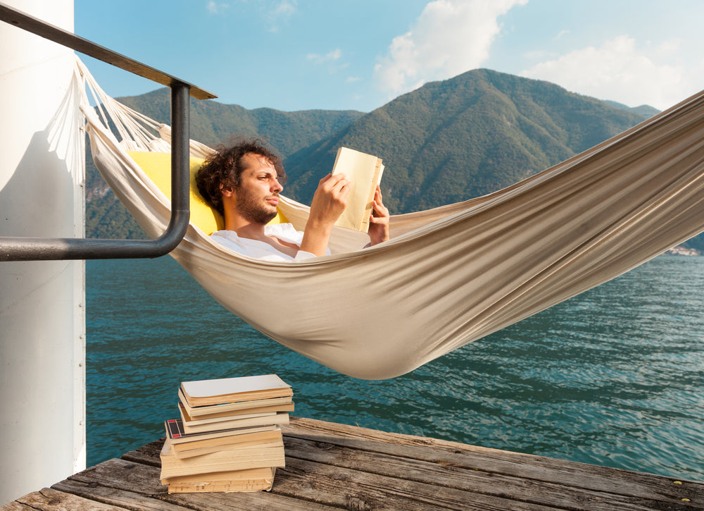 man reading on hammock 