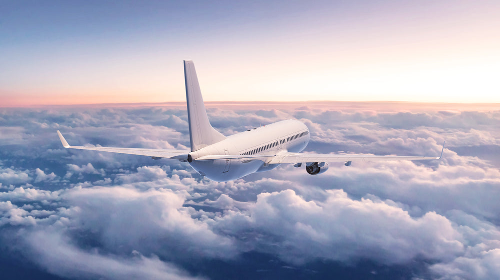 airplane flying over clouds