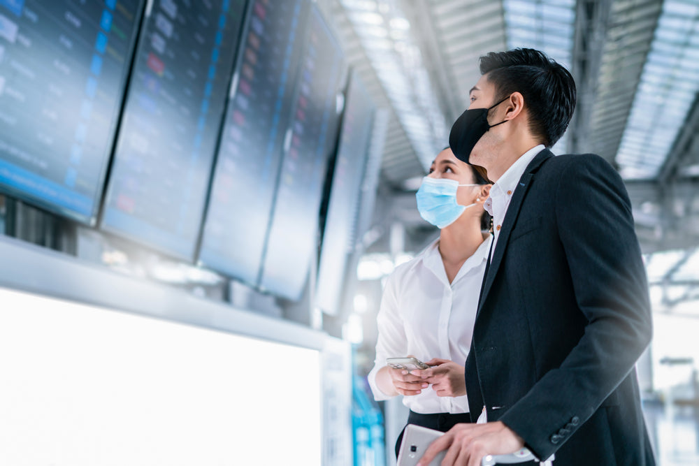 Couples looking at flight screen