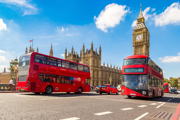 Double Decker buses in London near the Big Ben Clock Tower