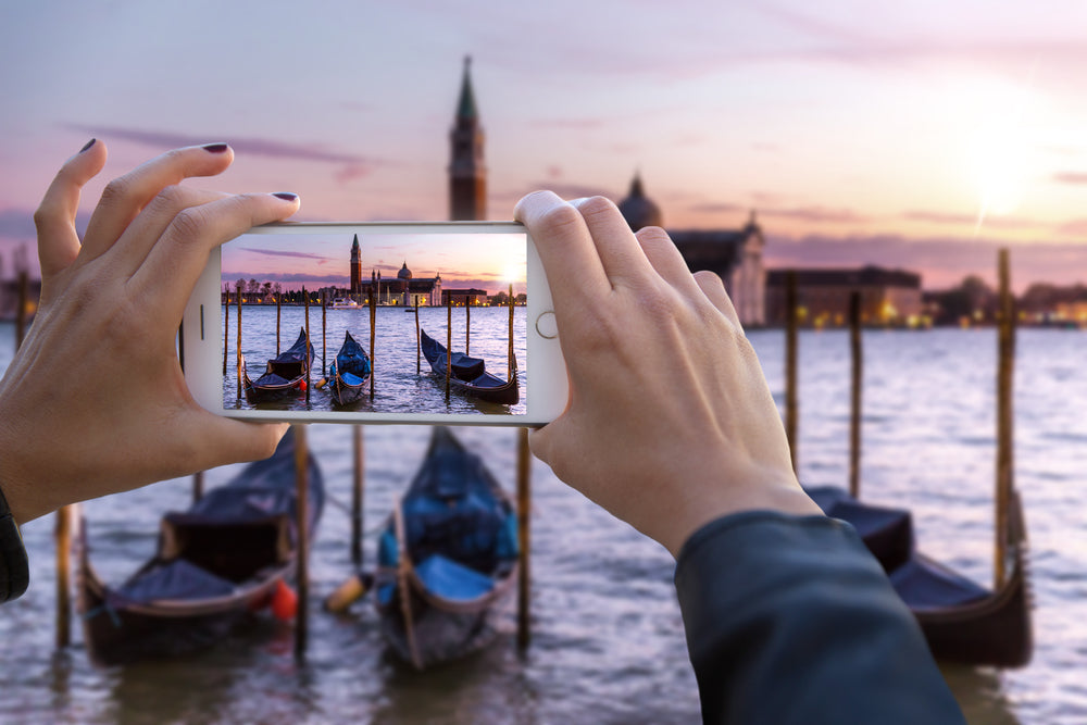 woman taking picture of boats