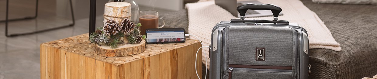 Travelpro rolling suitcase with phone charger powering a device