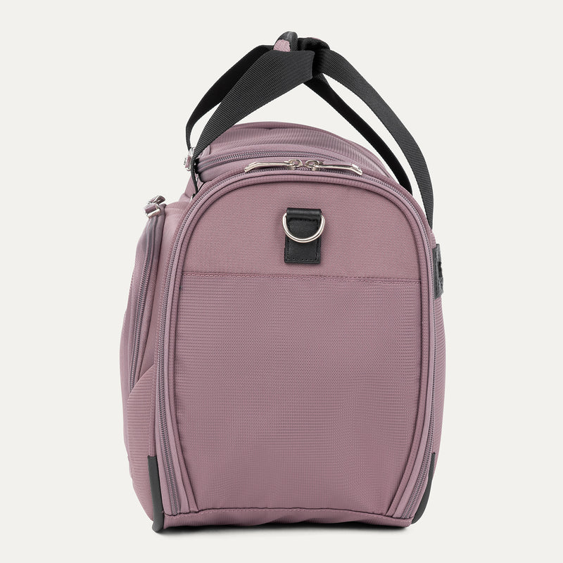 side profile view of the dusty rose pink travelpro maxlite 5 soft tote showing the reinforced side panel, top carry handles, and the metal d-ring for shoulder strap attachment.