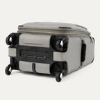 Bottom view of Maxlite® 5 Carry-On Spinner in gray, showing the four 360° spinner wheels, reinforced corner guards, and the durable base for stability and protection.
