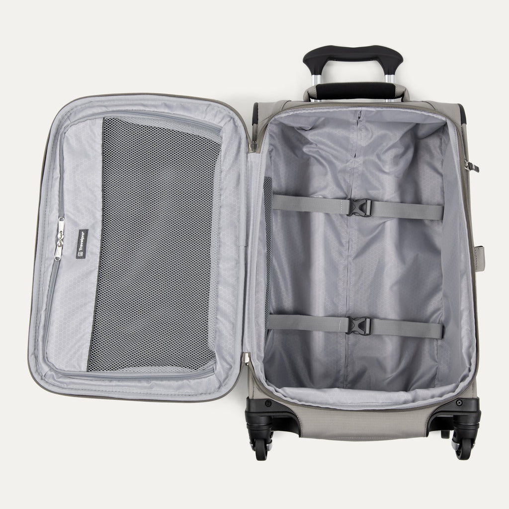 Interior view of the Maxlite® 5 Carry-On Spinner in gray, featuring a spacious main compartment with adjustable tie-down straps and a zippered mesh pocket on the lid for organized packing.
