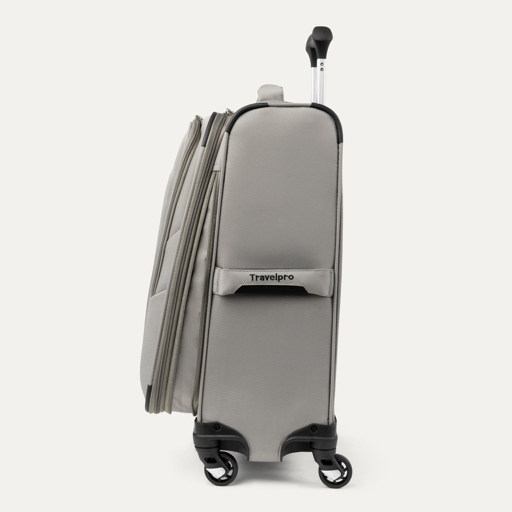 Side view of Maxlite® 5 Carry-On Spinner in gray, showcasing the side carry handle with Travelpro® branding, dual spinner wheels, and the lightweight profile.
