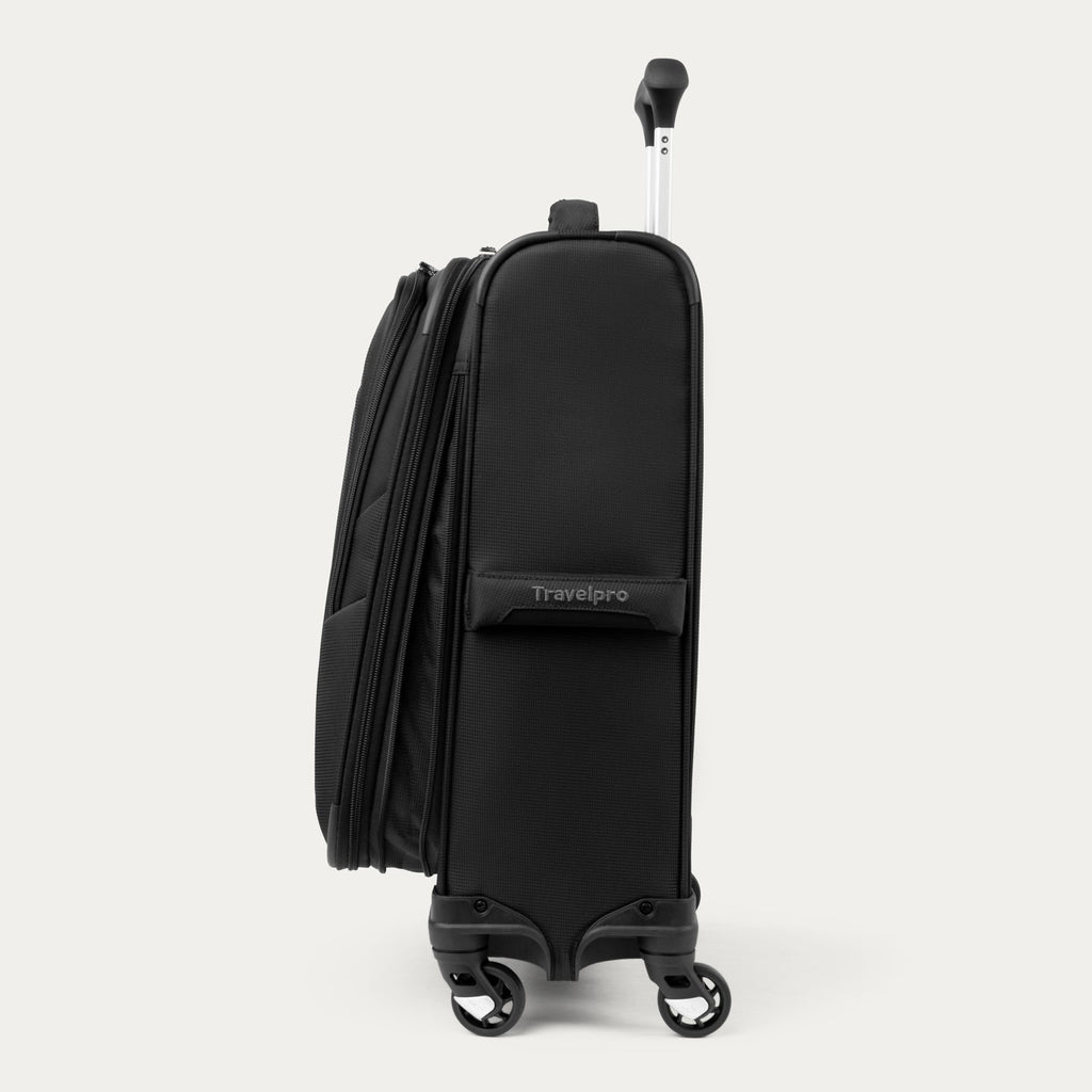 Side view of black suitcase with visible 'Travelpro' branding on a white background

