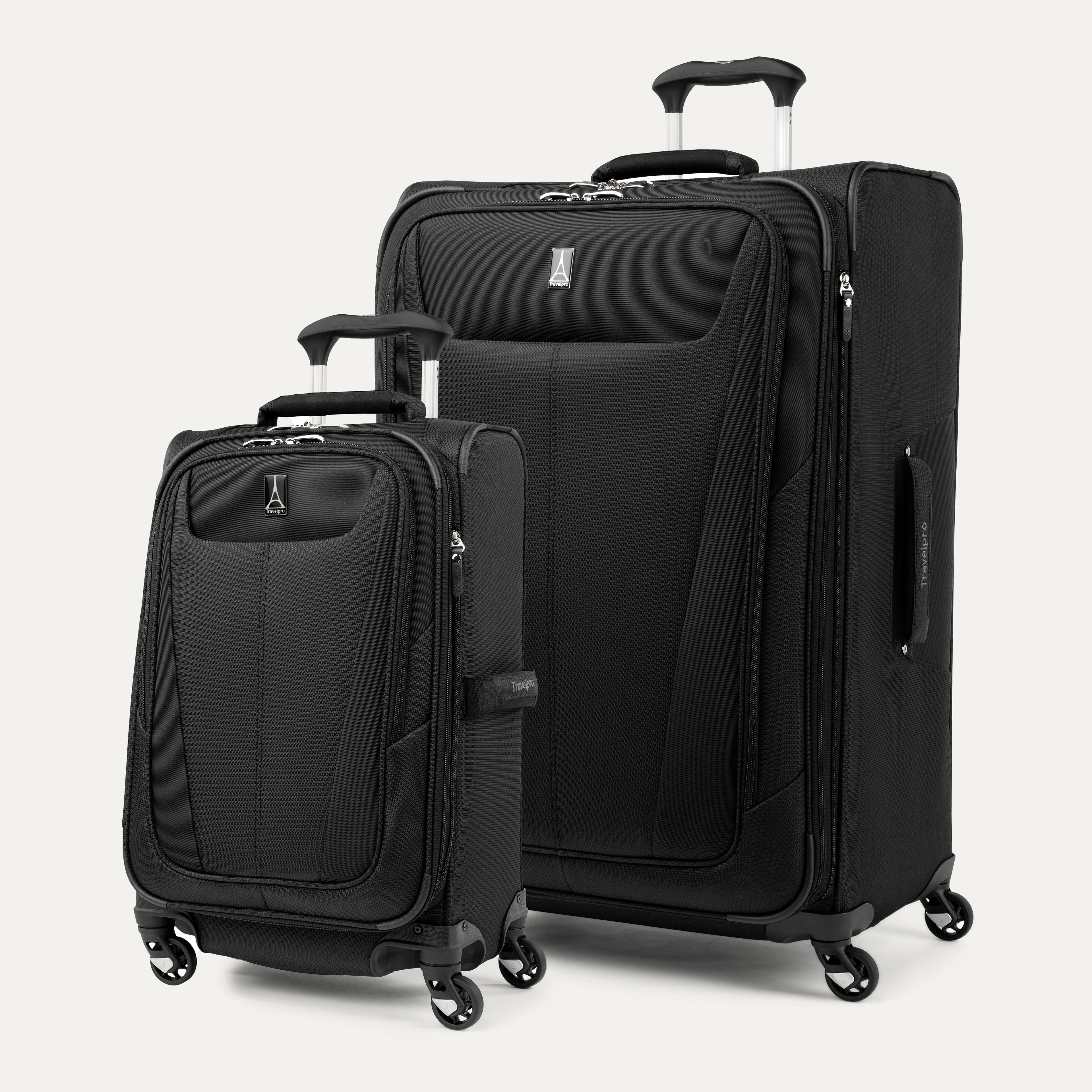 Two black suitcases of different sizes on a white background