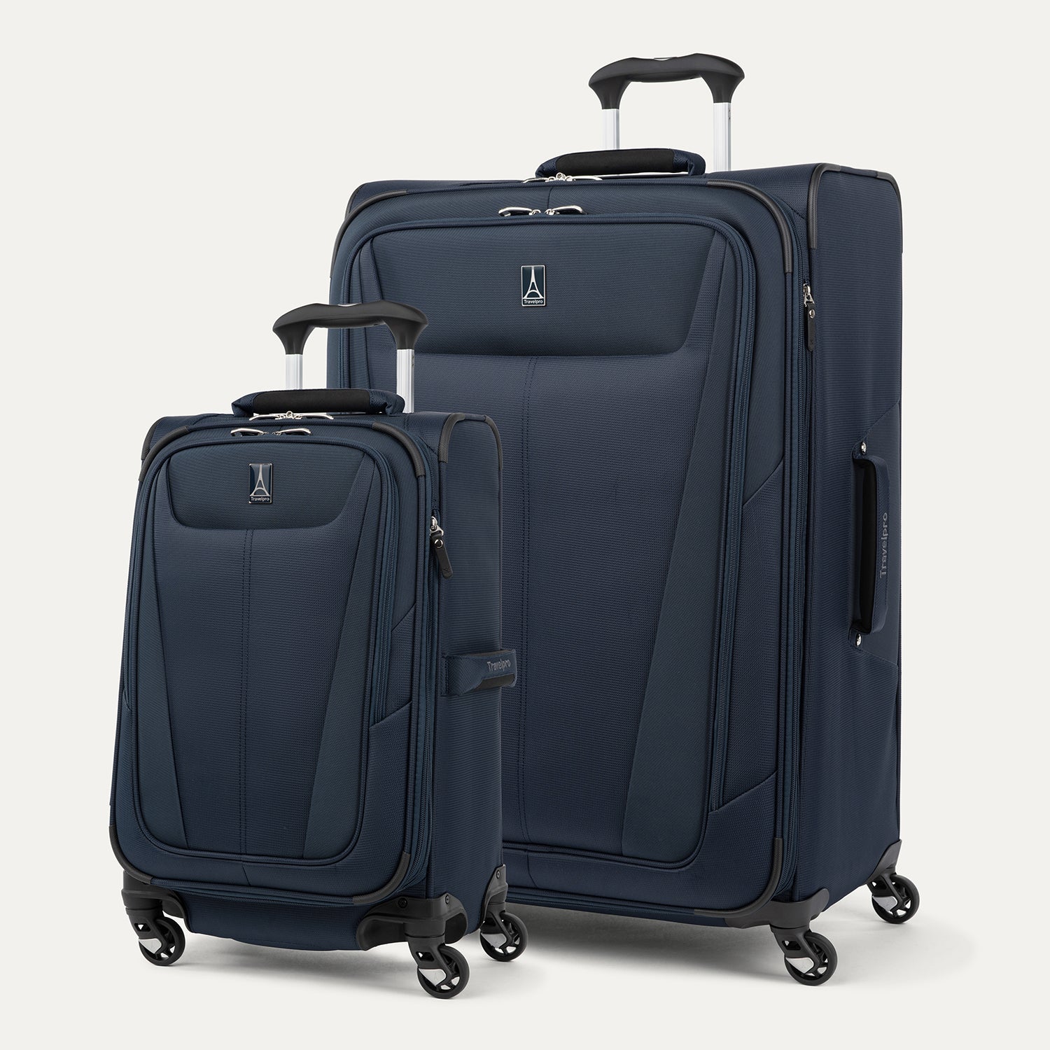 Two navy blue suitcases with wheels on a light gray background