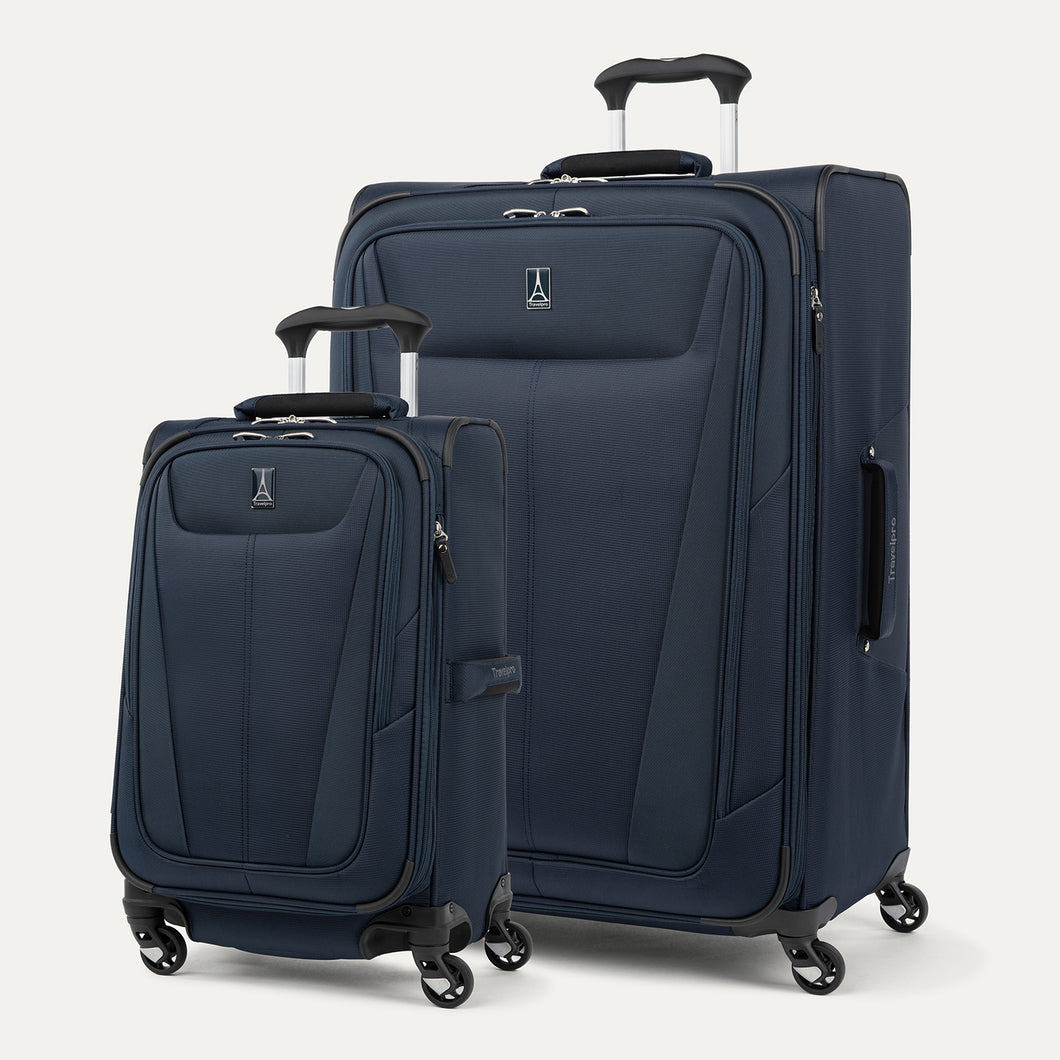Two navy blue suitcases with wheels on a light gray background