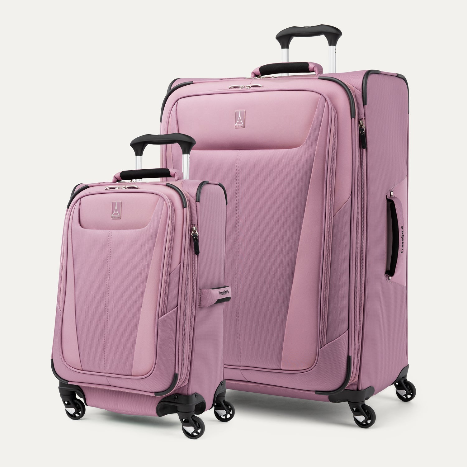 Two pink suitcases with black handles and wheels on a white background