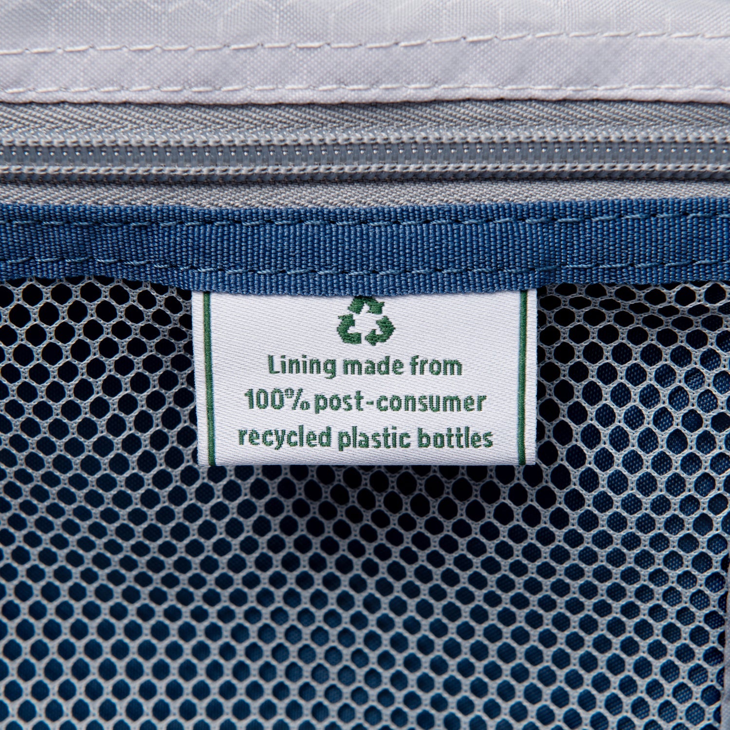 Textile with a recycling label indicating 100% post-consumer recycled plastic bottles lining.