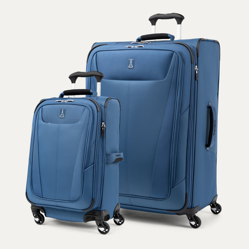 Two blue suitcases of different sizes on a white background