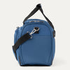 Side view of blue tote with black straps on a white background