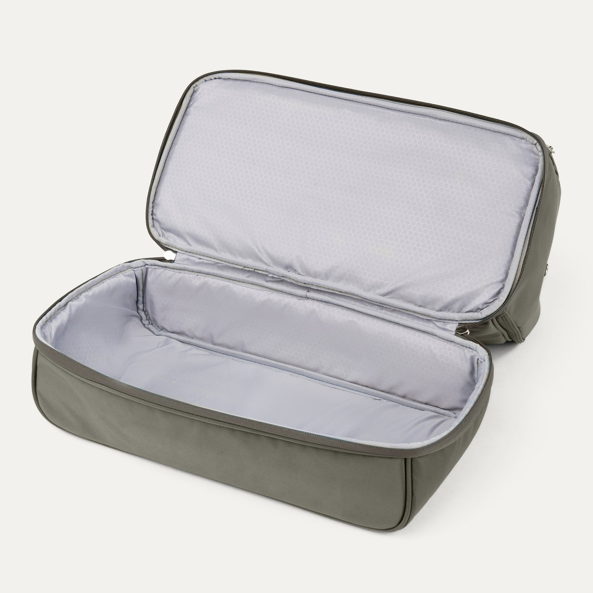 interior view of the open drop bottom compartment on the slate green travelpro maxlite 5 weekender showing the light gray lining and spacious packing area.