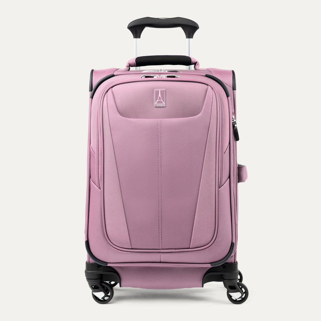 Front view of the dusty rose Maxlite 5 Compact Carry-On Spinner, showing the front zippered pocket, textured hardside/softside shell combination, and extended telescoping handle against a light gray background.