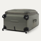 bottom and side view of the slate green travelpro maxlite 5 large check-in spinner showing the four 360 degree spinner wheels and the bottom molded handle cup for easy lifting.