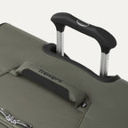 close up of the slate green travelpro maxlite 5 large check-in spinner showing the ergonomic contour grip on the powerscope lite handle and the cushioned top carry handle with travelpro branding.