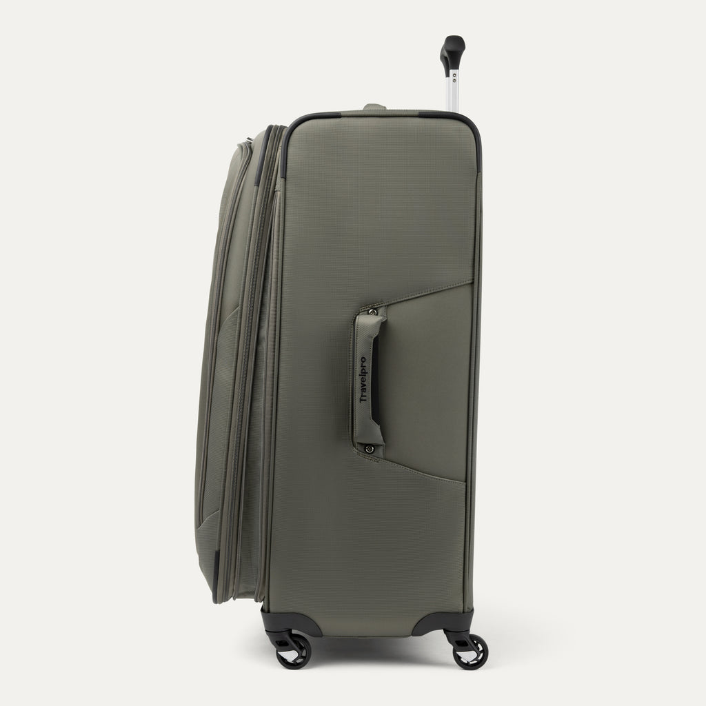 side profile view of the slate green travelpro maxlite 5 large check-in spinner showing the side carry handle, expansion zipper, and slim profile.