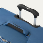close up of the ensign blue travelpro maxlite 5 large check-in spinner showing the ergonomic contour grip on the powerscope lite handle and the cushioned top carry handle with travelpro branding.