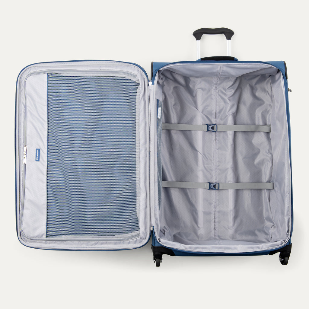 interior view of the open ensign blue travelpro maxlite 5 large check-in spinner showing the gray ecofab packing compartment with adjustable hold-down straps and a full-length mesh lid pocket.