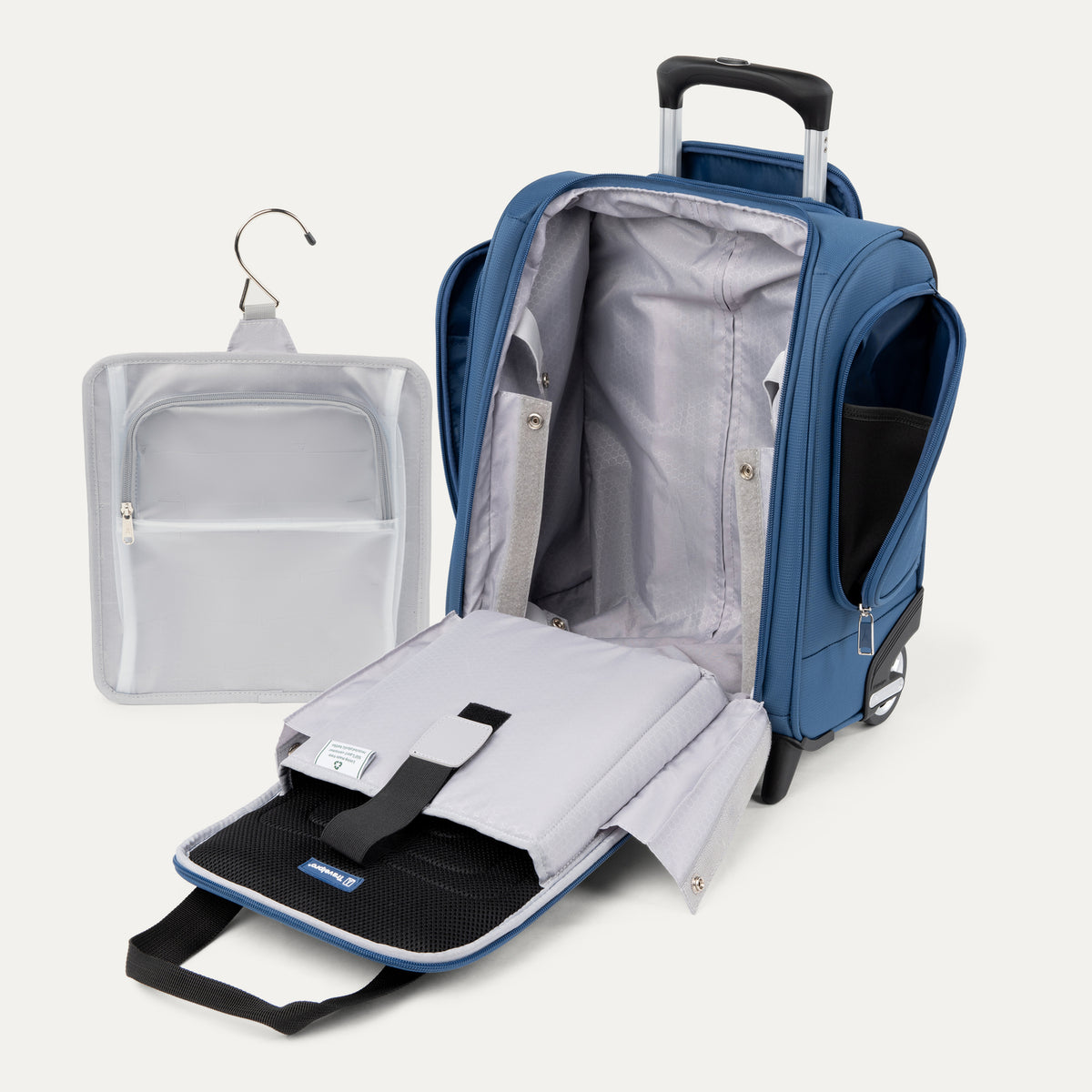 interior view of the open ensign blue travelpro maxlite 5 rolling underseat carry-on showing the light gray lining, padded laptop sleeve, and the removable hanging toiletry organizer.