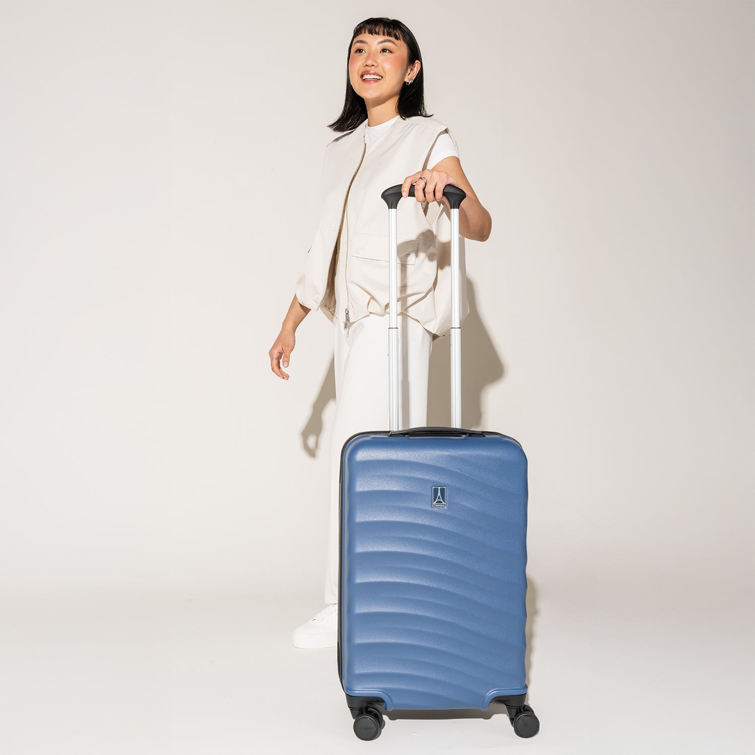 Person holding with the Travelpro Maxlite Air Carry-On Hardside Spinner in Ensign Blue