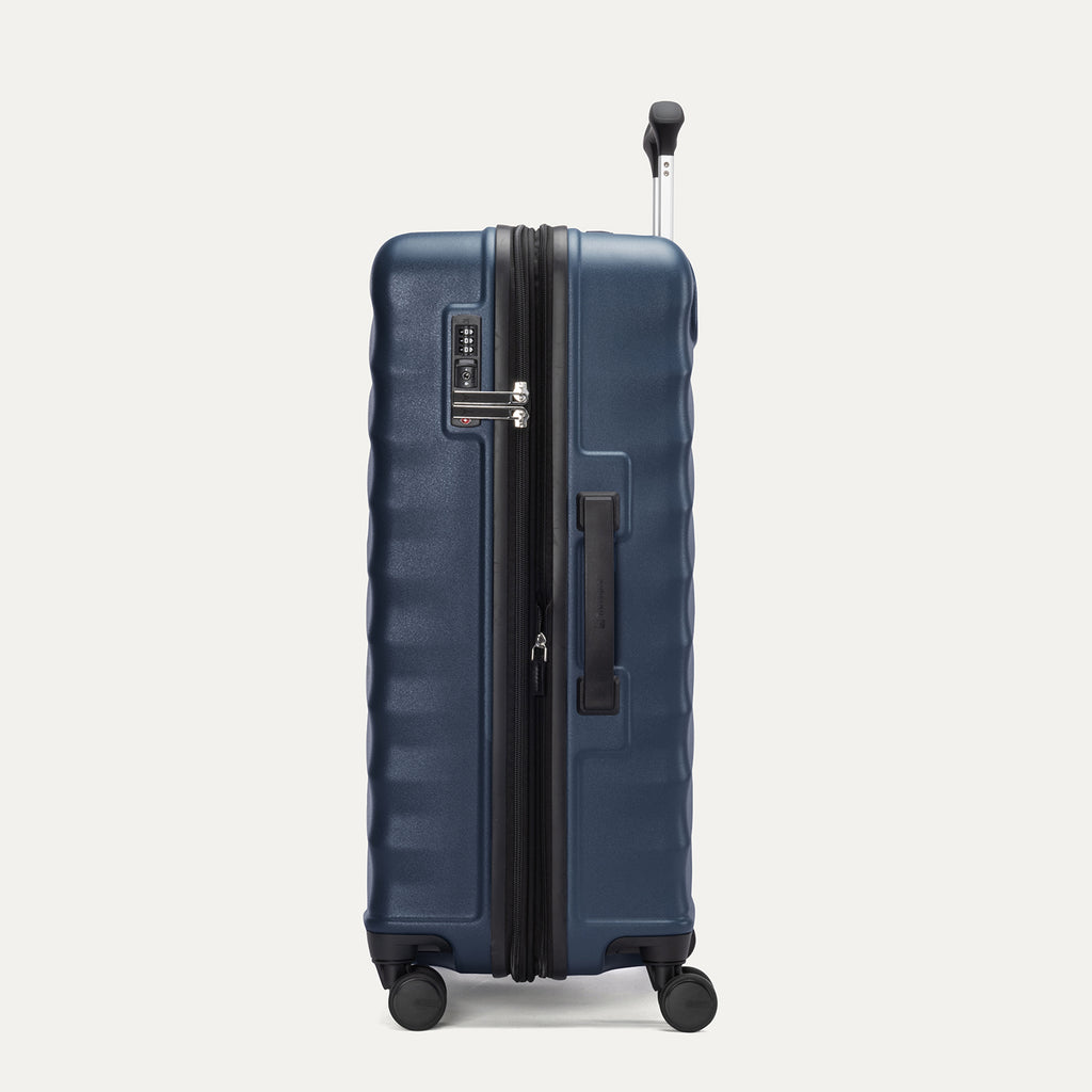 Side view of Travelpro Maxlite Air V2 Check-In Spinner in Midnight Blue, showing expandable zipper, Low-Profile Side Carry Handle, and extended PowerScope Lite Handle