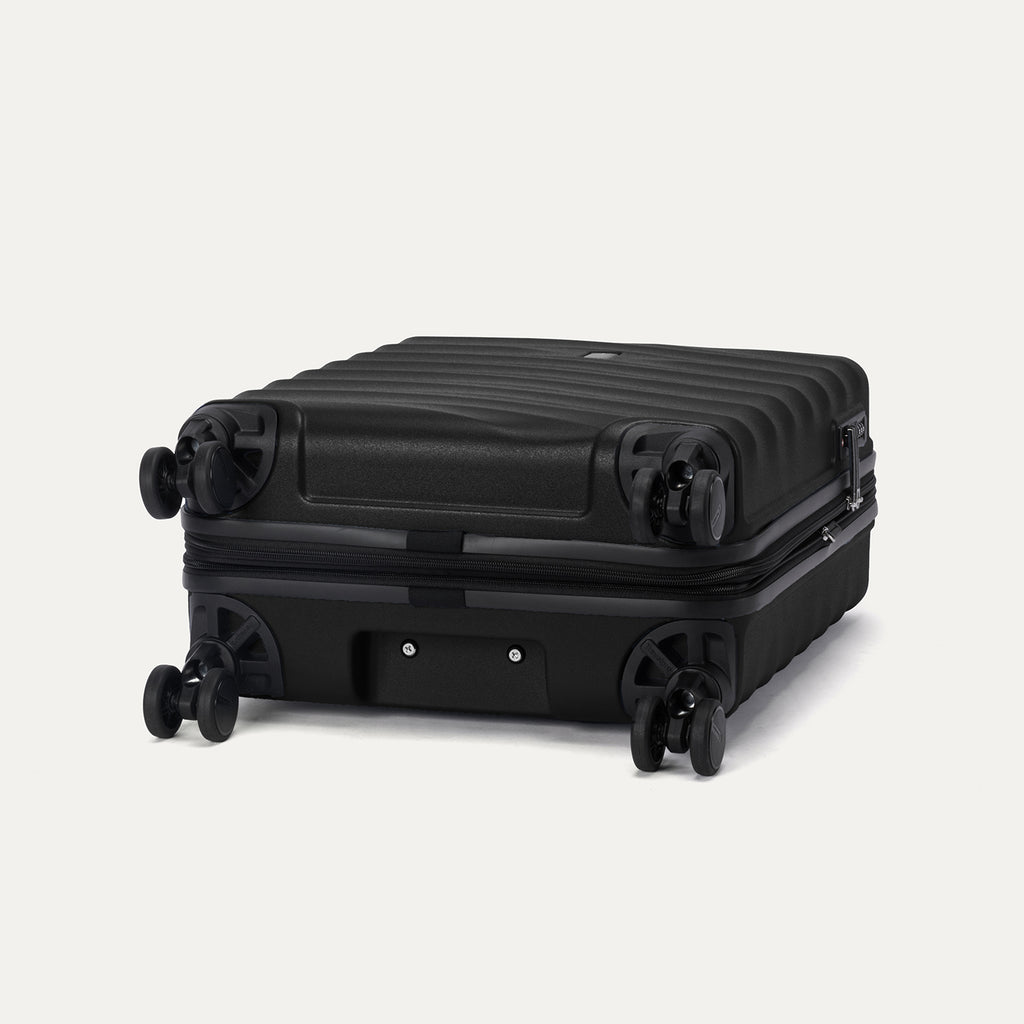 Bottom view of Travelpro Maxlite Air V2 Compact Carry-On Spinner in Black, showing durable wheels and textured shell
