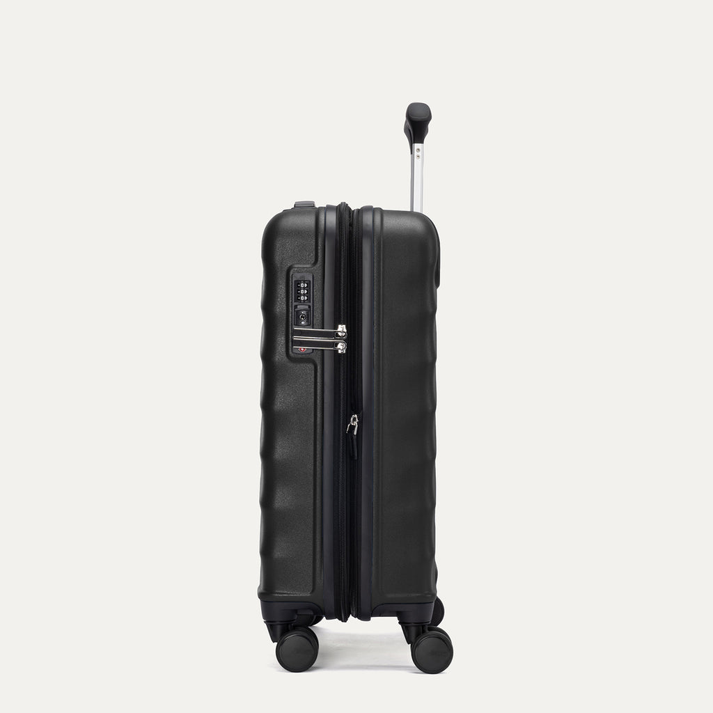 Side view of Travelpro Maxlite Air V2 Compact Carry-On Spinner in Black, featuring expandable zipper and TSA-approved lock with the handle extended.