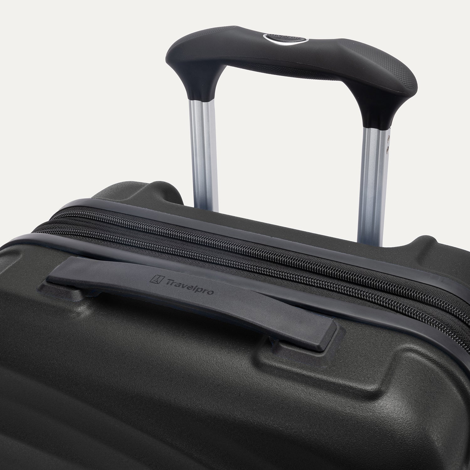 Top view of Travelpro Maxlite Air V2 Carry-On Hardside Spinner in Black, showing Contour Grip and PowerScope Lite Handle