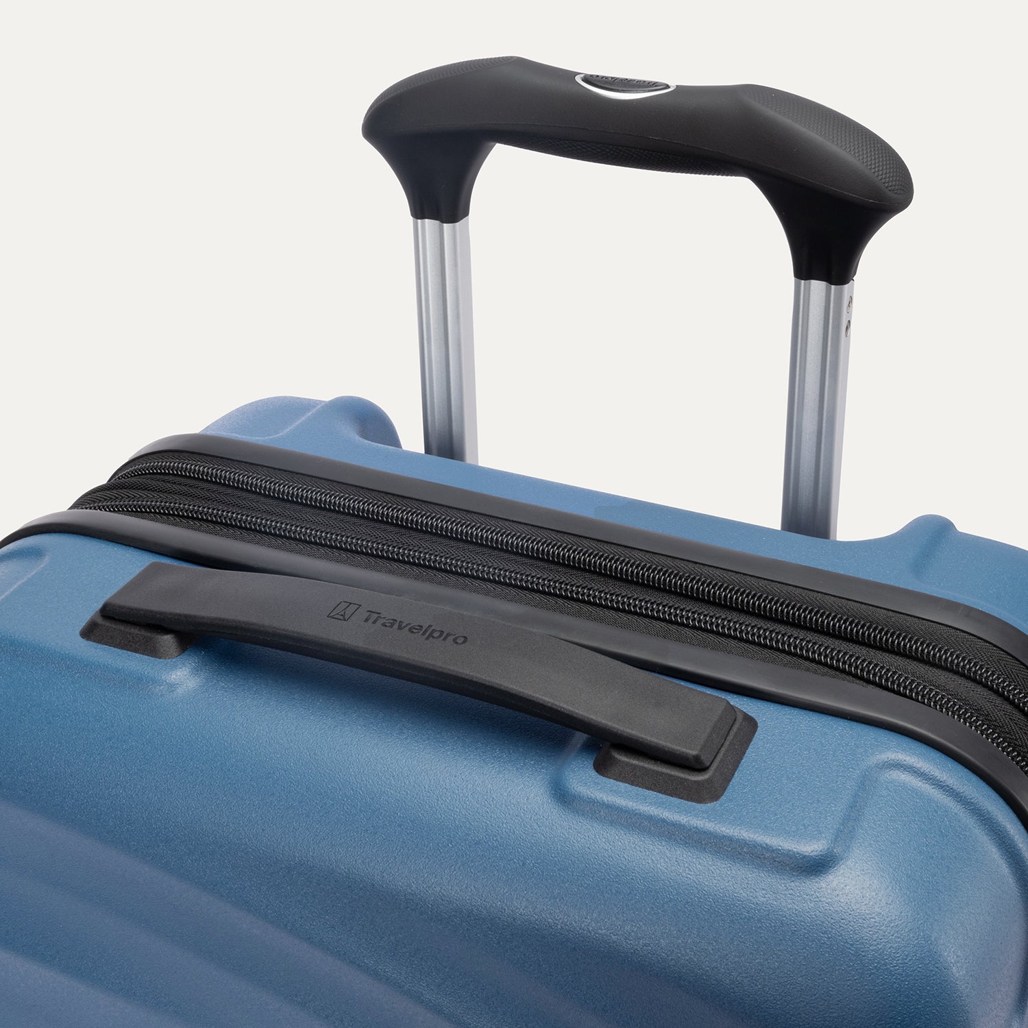 Top view of Travelpro Maxlite Air V2 Carry-On Spinner in Ensign Blue, showing Contour Grip and PowerScope Lite Handle.
