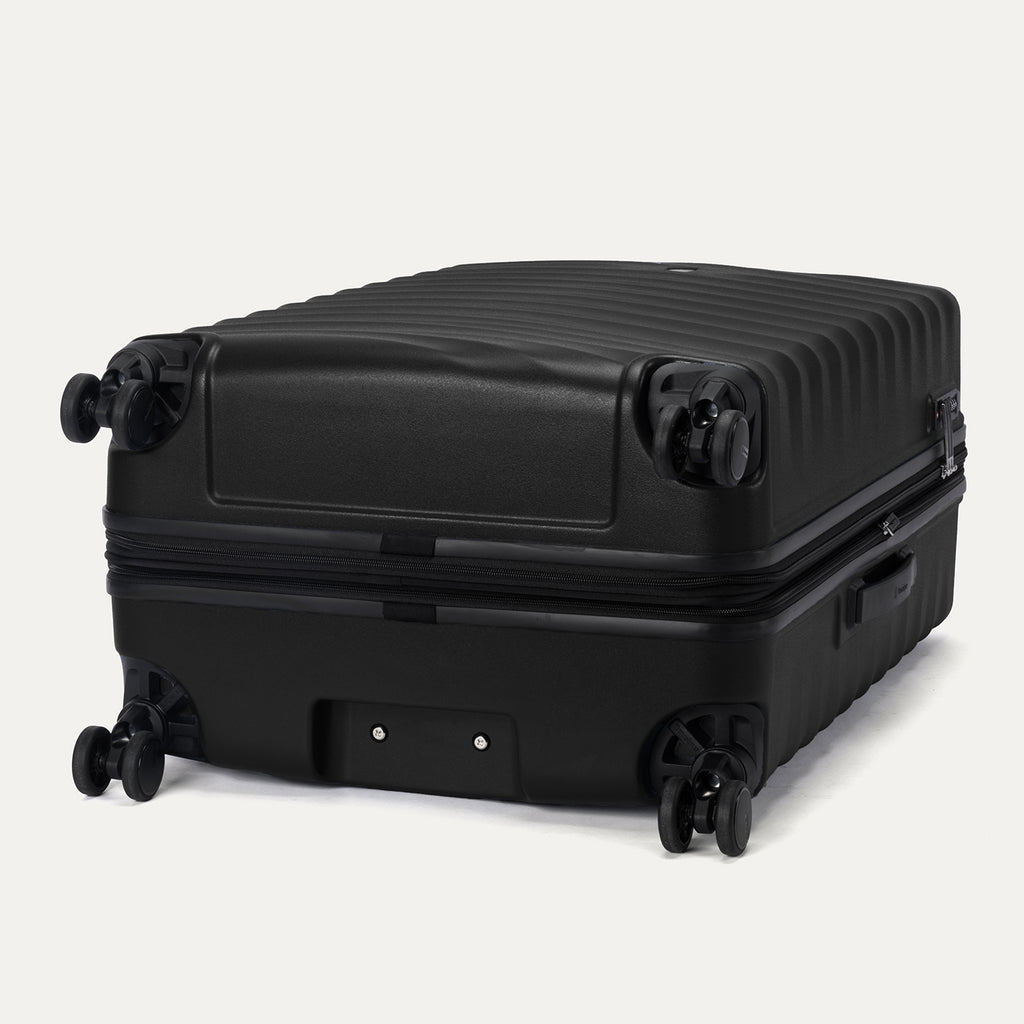 Bottom view of Travelpro Maxlite Air V2 Check-In Spinner in Black, showing dual spinner wheels and side carry handle.